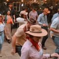 A group of people doing line dancing at a restaurant