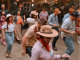 A group of people doing line dancing at a restaurant
