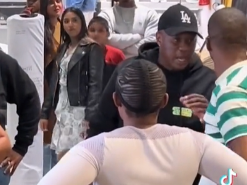A group of people surround a couple caught cheating in Gateway