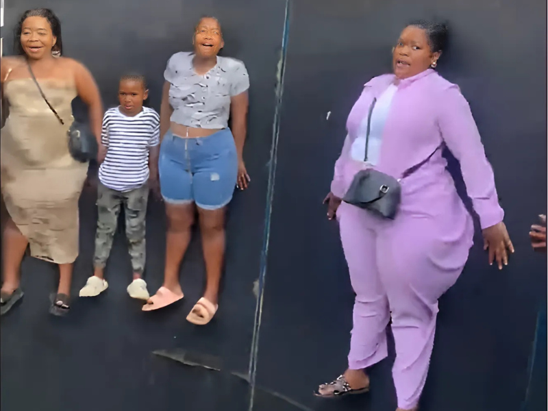 A group riding a fun fair ride looking scared