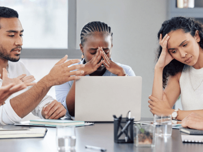 A group shot of business people looking stressed