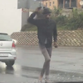 A guy dancing at the traffic light intersection