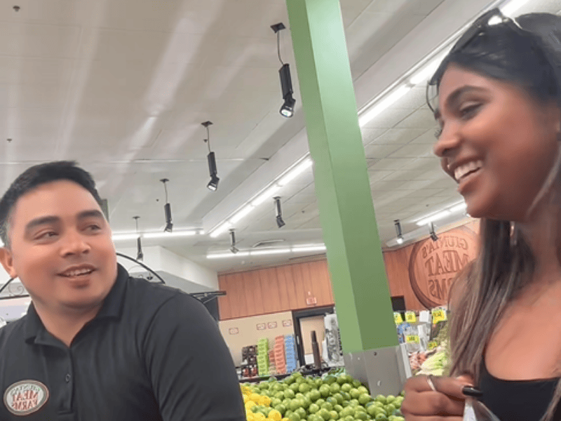 A guy talking with a young woman as she shops