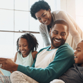 A happy family reading a book together on the couch