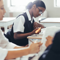A high school student studying at her desk in classroom
