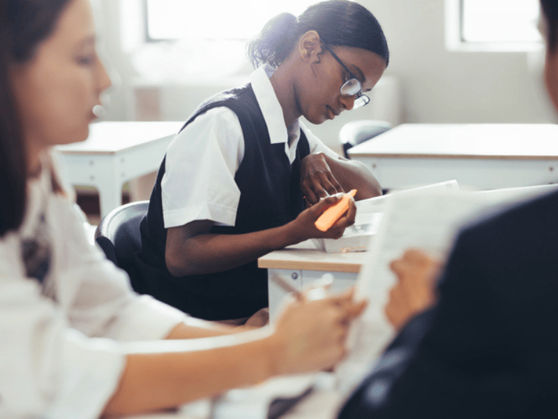 A high school student studying at her desk in classroom