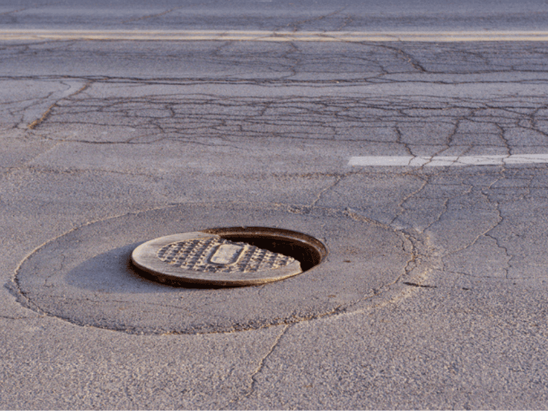 A hole in the road as drain cover is out of place