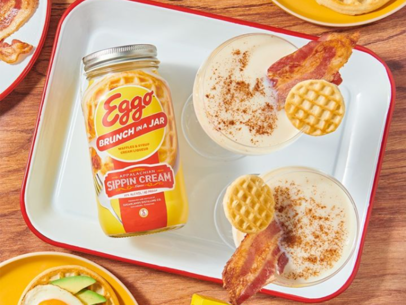 A jar of sipping cream next to a table top of food