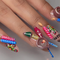 A lady has Diwali themed manicured nails