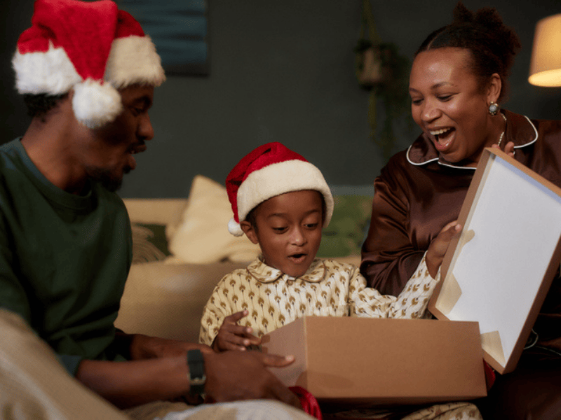 A little boy opening his gifts during Christmas
