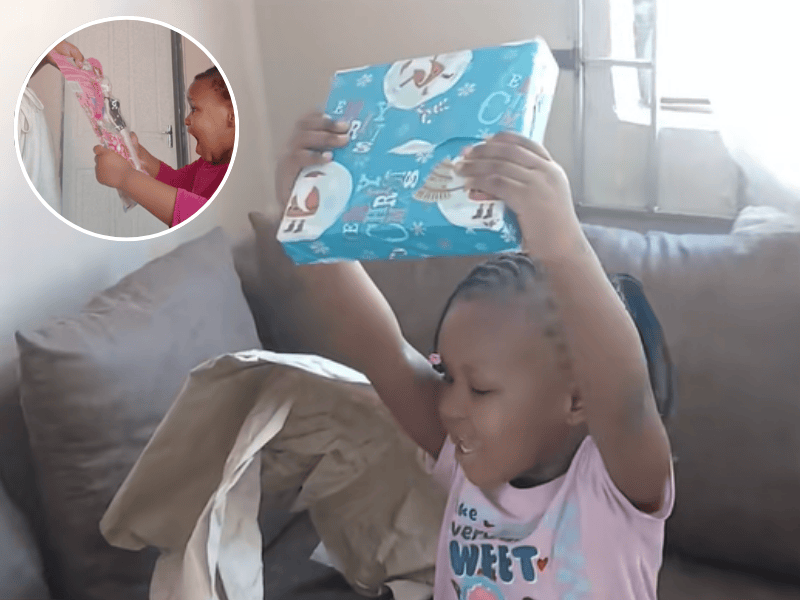 A little girl excited about her Christmas gift