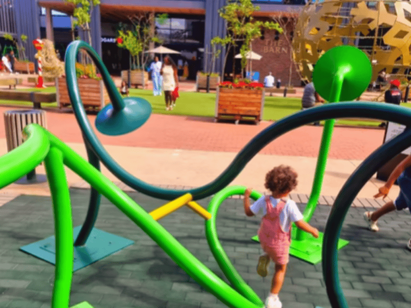 A little girl playing in a play area at Westown Square