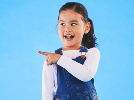 A little girl pointing her finger toward something