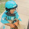 A little girl poses as a Checker Sixty60 delivery person at her doorstep
