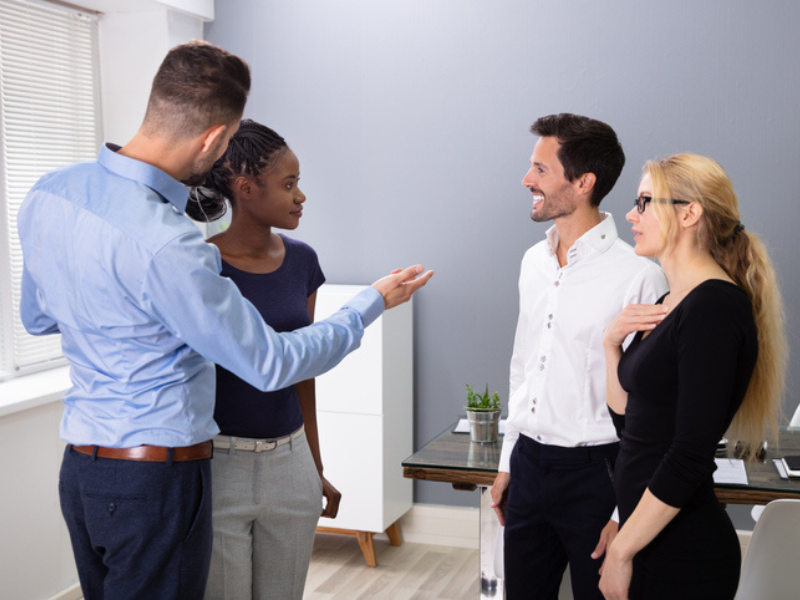 A male manager introduces a new employee to her co-workers