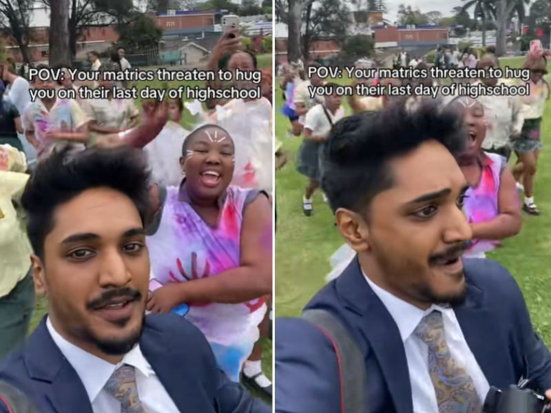 A male teacher wearing a suit runs away from his matric students