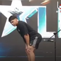 A man bends over a microphone and passes gas for a Guinness World Record
