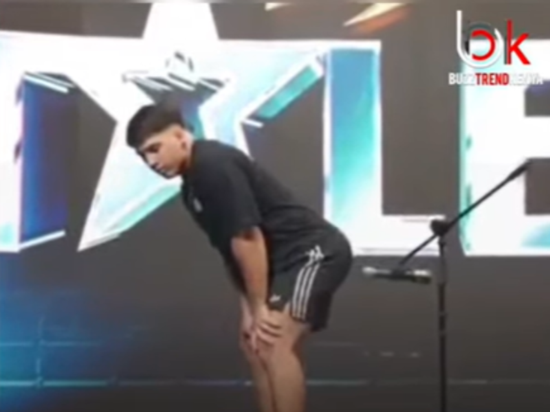 A man bends over a microphone and passes gas for a Guinness World Record