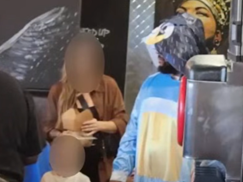 A man dressed up as Bluey at a restaurant