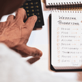 A man hand calculating the wedding expenses