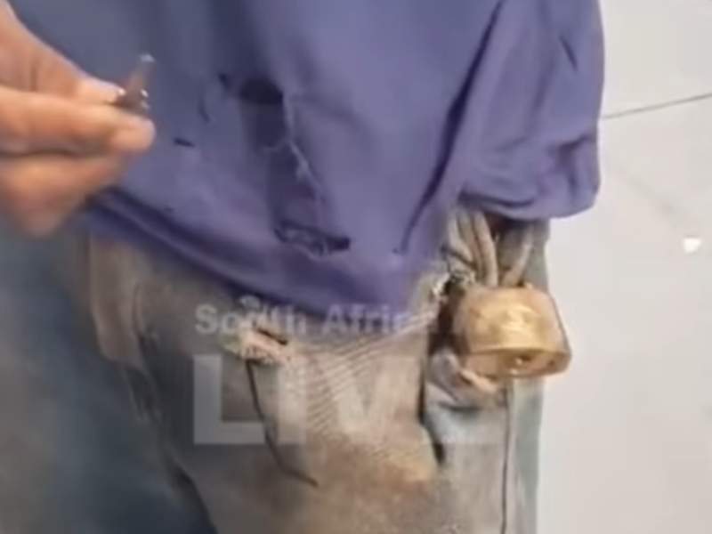 A man holds a key in his hand for a lock on his jean pocket