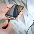 A man is plugging a charger into his smartphone