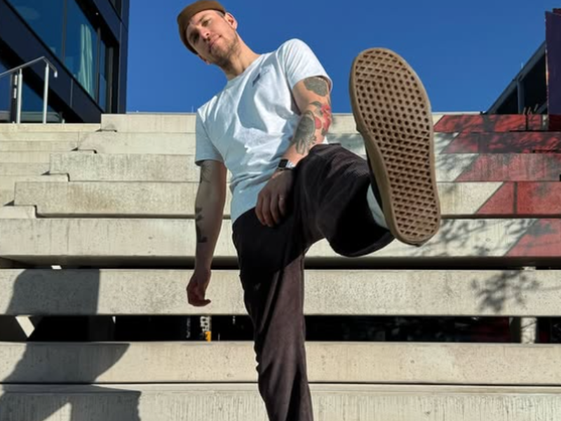 A man lifts his leg up at a staircase