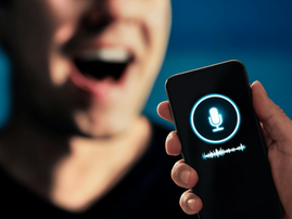 A man pronouncing words into a smartphone app