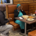 A man proposes to a lady at a restaurant