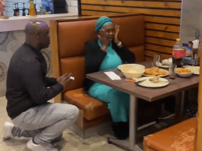 A man proposes to a lady at a restaurant