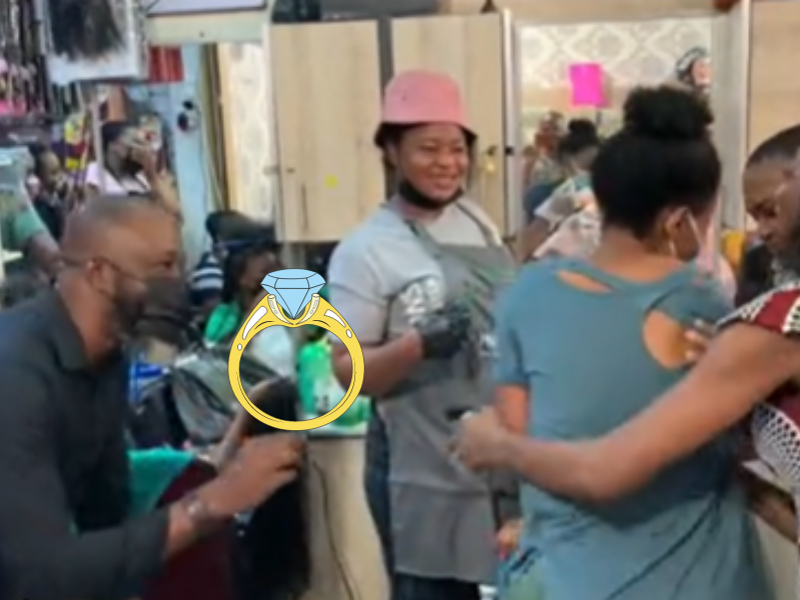 A man proposes to a woman at a hair salon