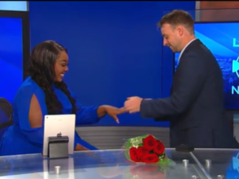 A man proposes to a woman in news studio