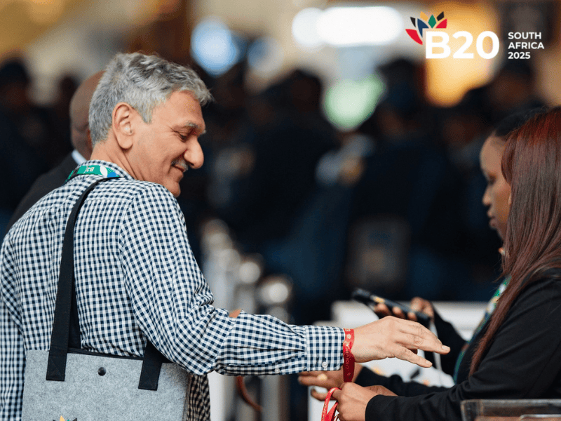 A man receives his entry bracelet at the B20 summit in South Africa