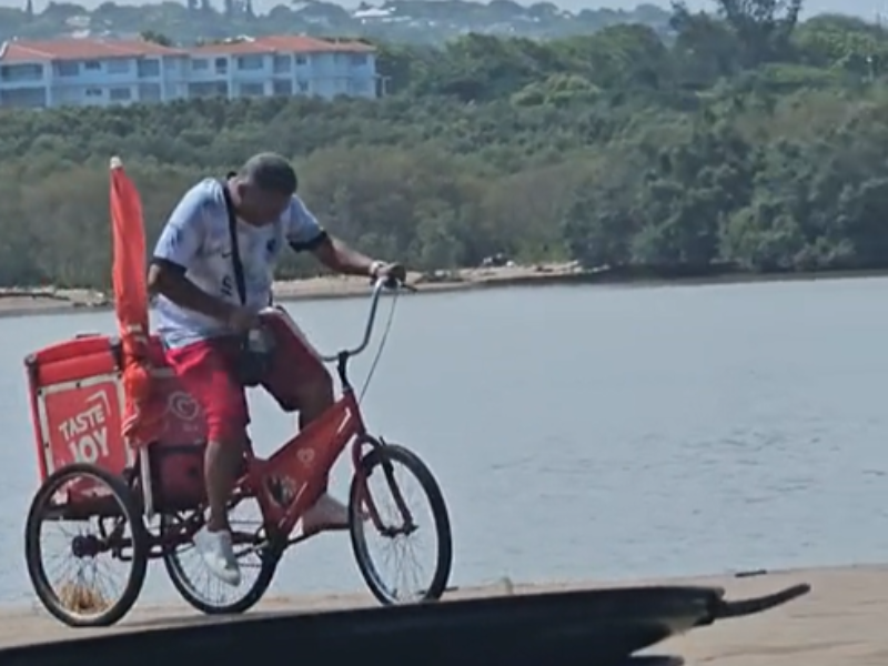 A man riding an ice cream bicycle