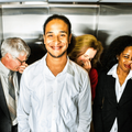 A man in a lift while people hold their noses