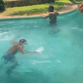 A man struggles to swim inside the deep end of a pool
