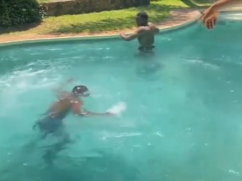 A man struggles to swim inside the deep end of a pool