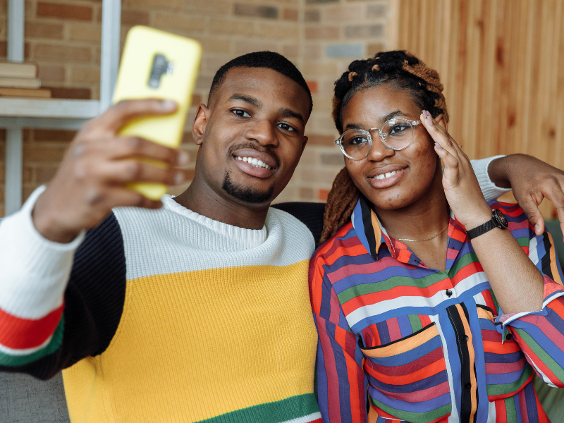 A man taking a selfie with a woman
