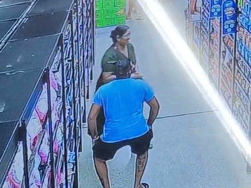 A man twerks while shopping with his wife at a grocery store
