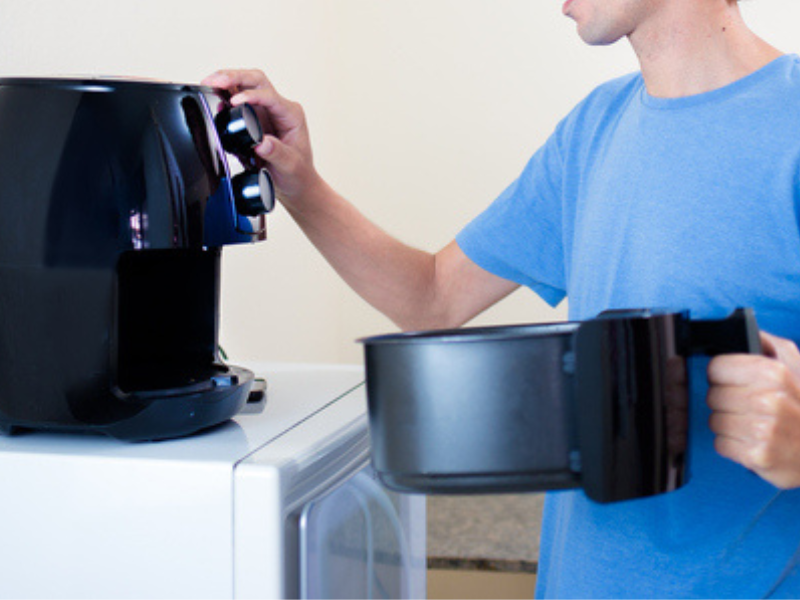 A man using an air fryer