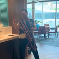 A man dances near a wash basin inside a cruise ship