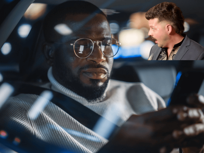 A man wearing glasses looks at his smartphone inside car