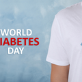 A man with a light blue ribbon and paper blood drop in support of World Diabetes Day