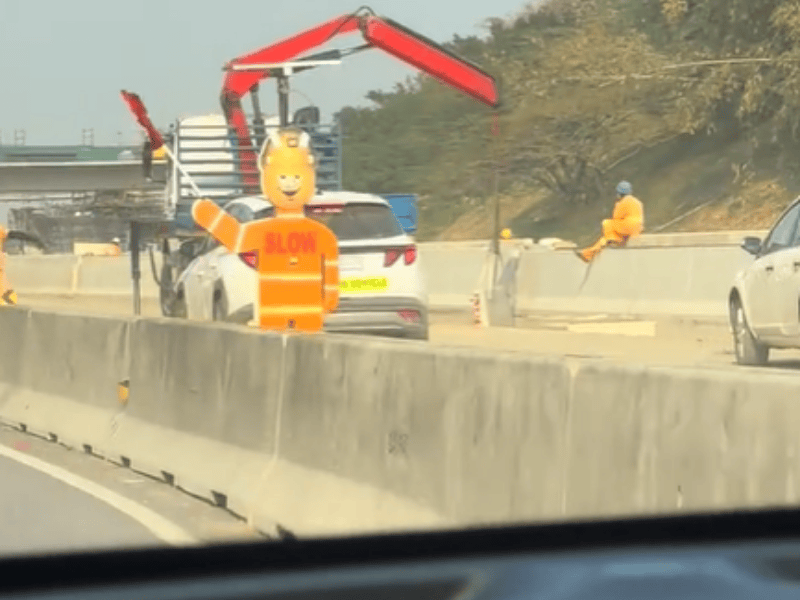 A mechanical flag person waving a flag on N2 freeway