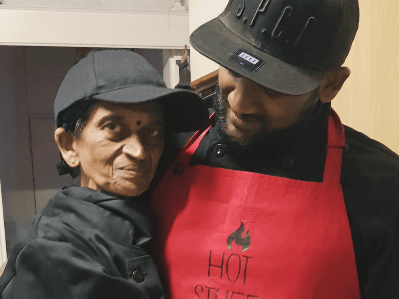 A mother and son hug one another