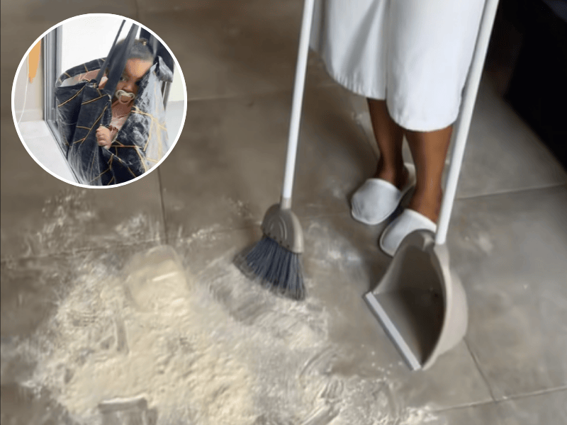 A mother cleans up the kitchen floor from flour and puts baby inside grocery bag