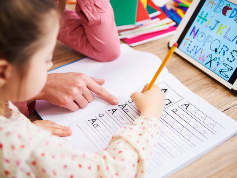 A mother helping her child with homework