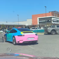A colourful Porsche 911 Carrera T driving around a car park