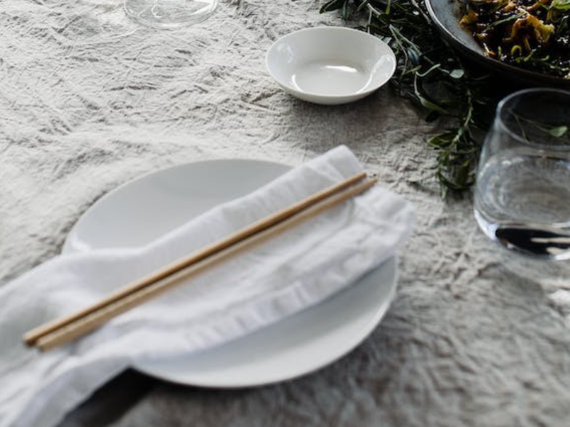 A pair of chopsticks on a side plate