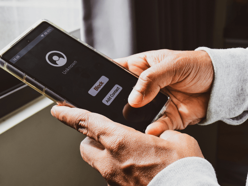 A person checking phone with a number